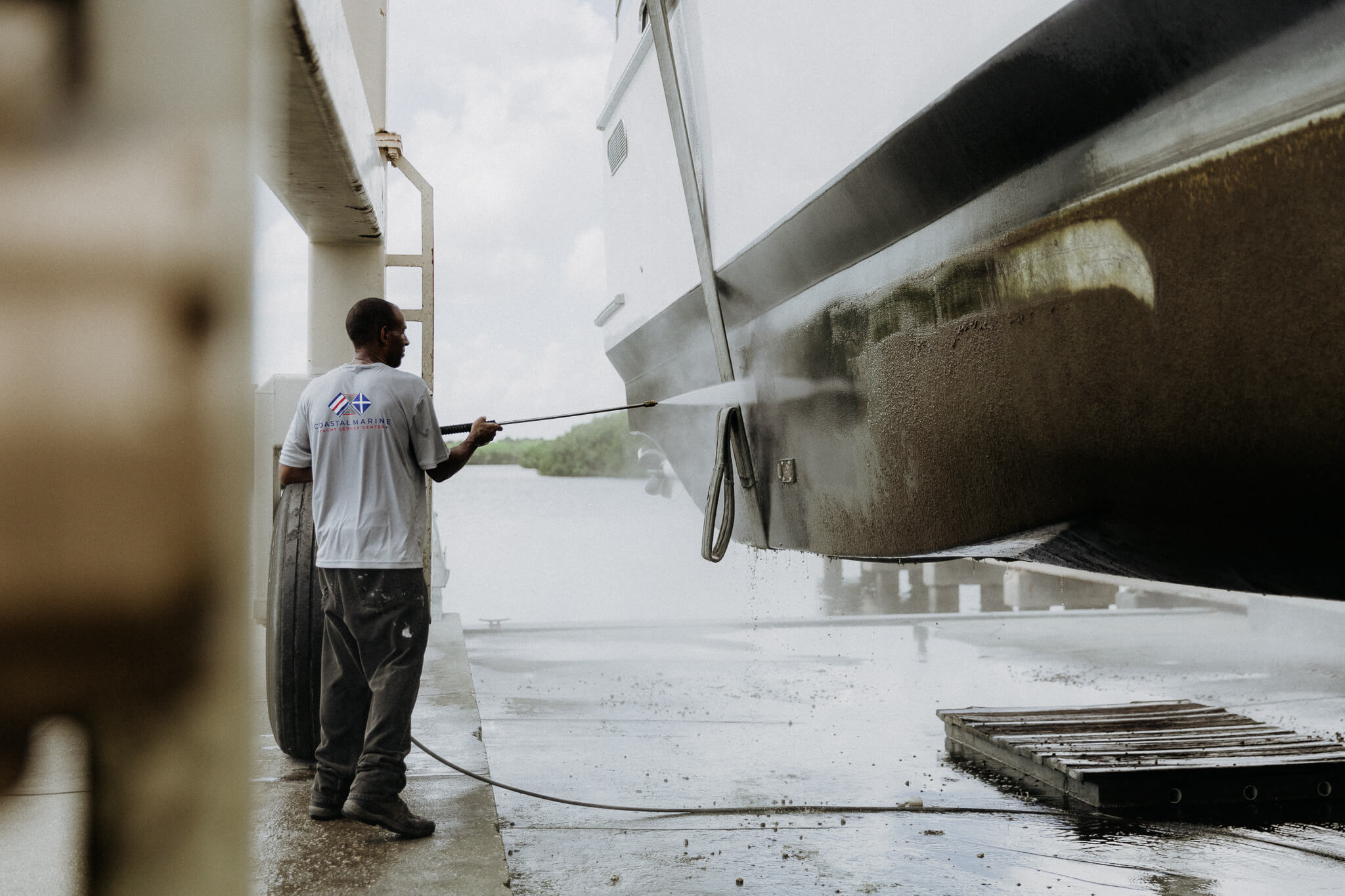 Coastal Marine Yacht Service Center man working on a boat bottom job