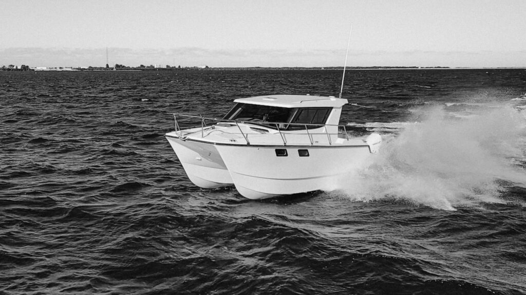power catamaran cabin cruiser on body of water