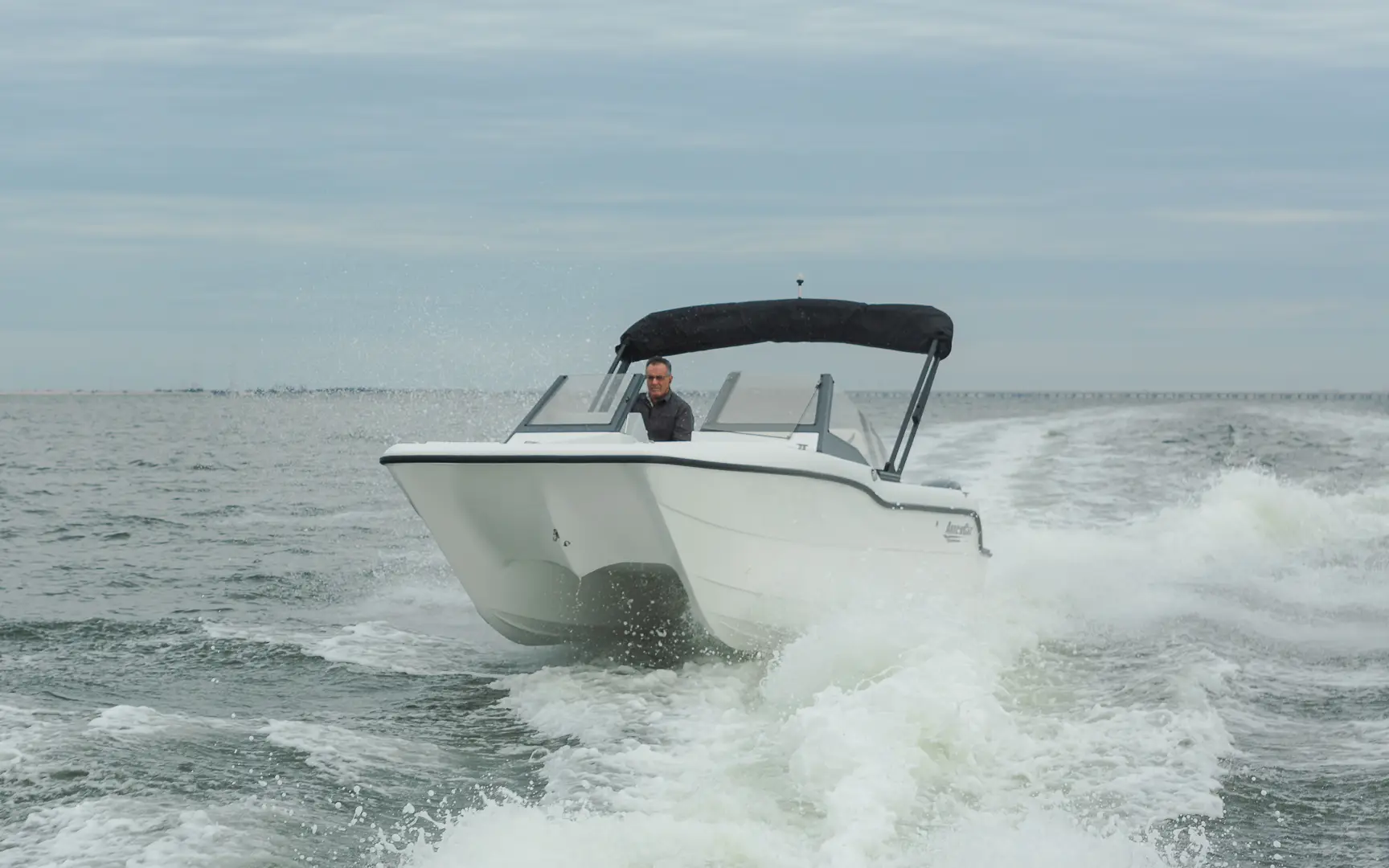 small power catamaran boat on the water